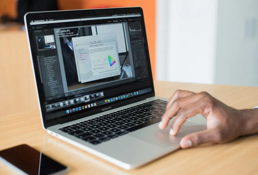 Laptop workspace used to plan website design costs and online presence for a Kenyan business